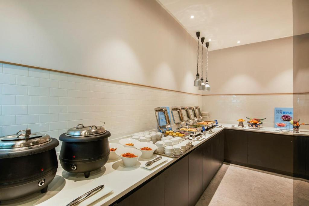a kitchen with two pots and pans on a counter at Holiday Inn Express Shanghai Xuhui Binjiang, an IHG Hotel in Shanghai