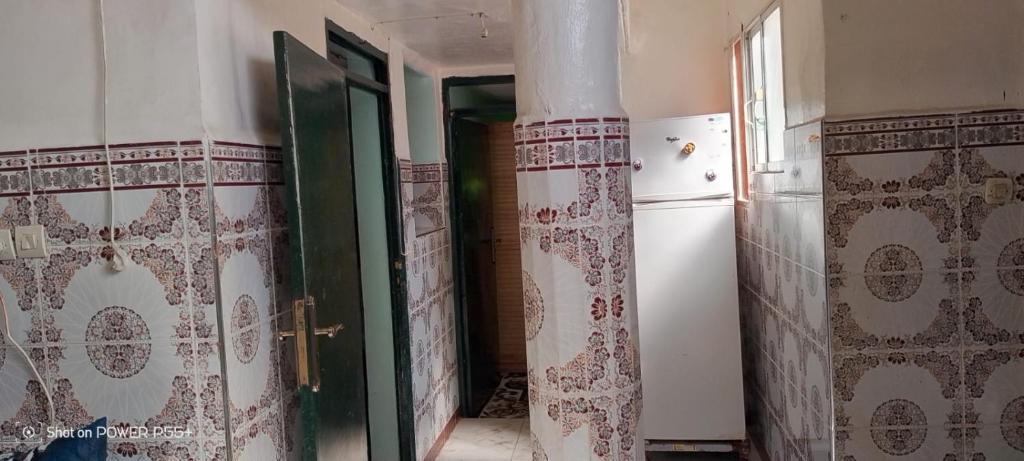 a kitchen with a refrigerator and a door in a room at luxury apartment in Marrakesh