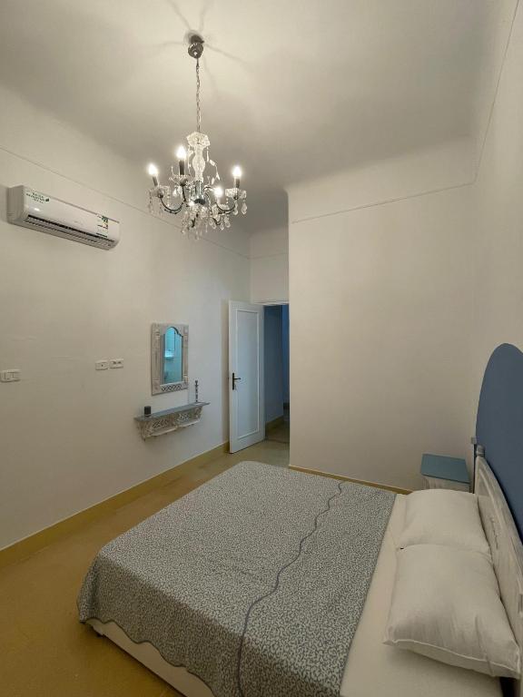 a bedroom with a bed and a chandelier at Nomads Hostel Tunisia in Tunis