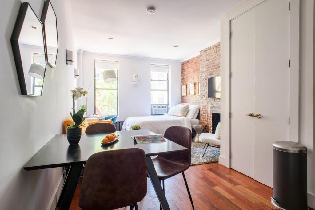 Habitación con cama, mesa y sillas. en 24-10 Studio Prime Gramercy WD in Unit en Nueva York