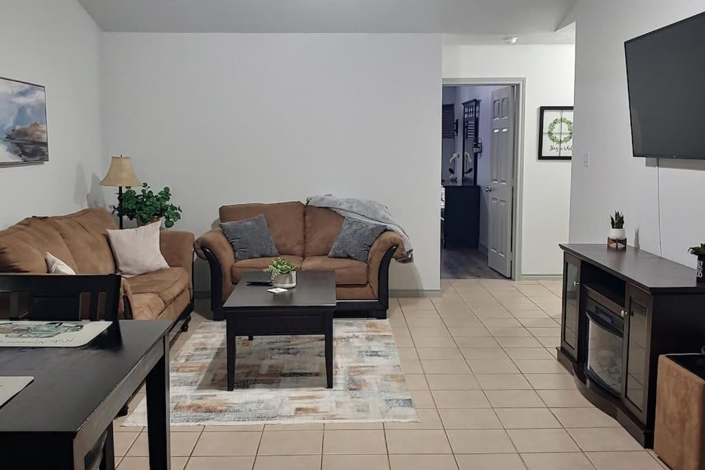 a living room with a couch and a table at Relax and Unwind in Bryan