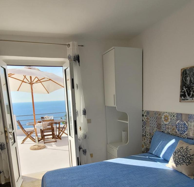 a bedroom with a bed and a view of the ocean at Ponza Le Forna in Ponza