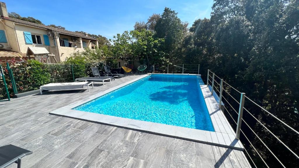 une piscine sur une terrasse à côté d'une maison dans l'établissement Casa maria, à Porto-Vecchio
