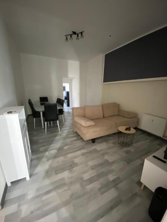 a living room with a couch and a table at Monteurwohnung für bis zu 5 Personen in Marpingen