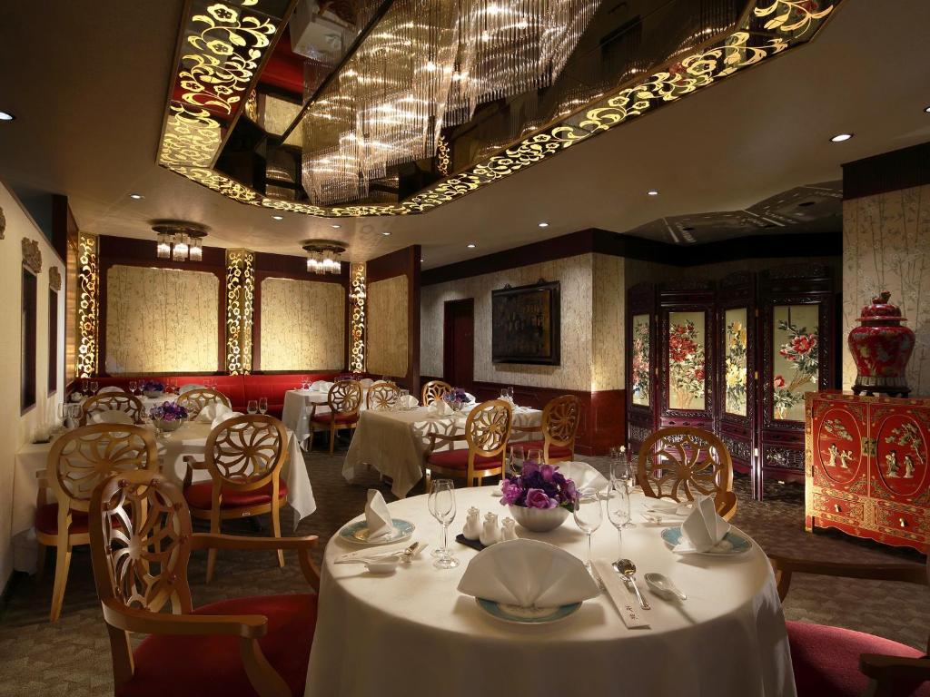 a dining room with tables and chairs with white table linen at ANA Crowne Plaza Hotel Kyoto by IHG in Kyoto