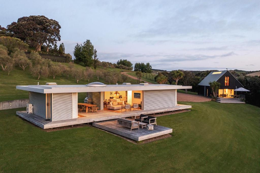a modular home with a deck on a lawn at Number 29 in Oneroa