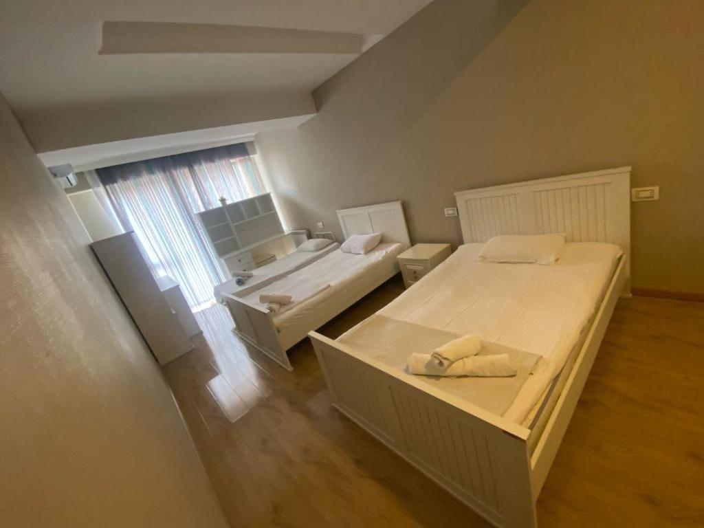 a small room with two beds and a bathroom at Baku - Park Azure with sea view two bedrooms and one living room in Baku