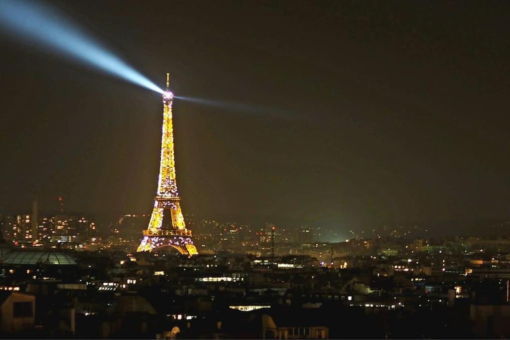 a view of the eiffel tower at night at Luxury flat with amazing view on Eiffel Tower in Paris