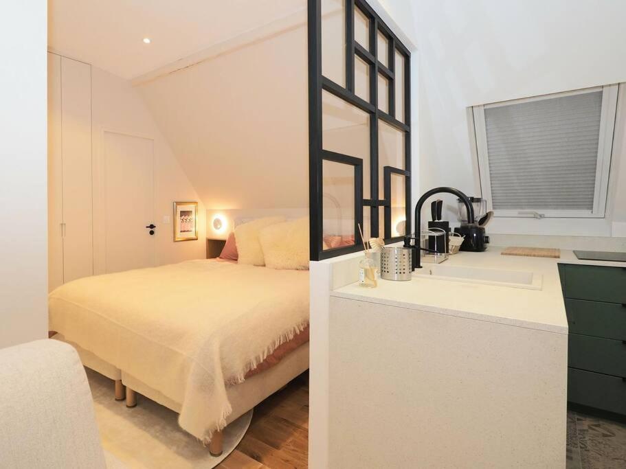 a bedroom with a bed and a sink with a mirror at Luxury flat with amazing view on Eiffel Tower in Paris