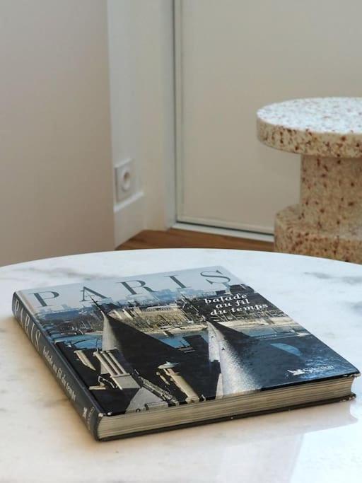 a book sitting on top of a table at Luxury flat with amazing view on Eiffel Tower in Paris