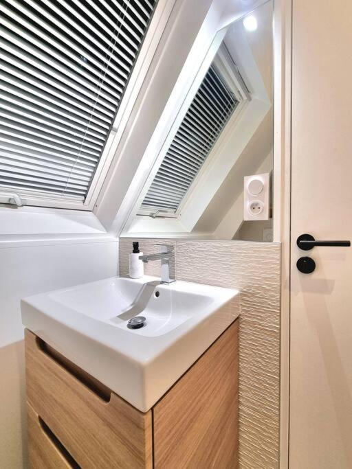a bathroom with a sink and a window at Luxury flat with amazing view on Eiffel Tower in Paris