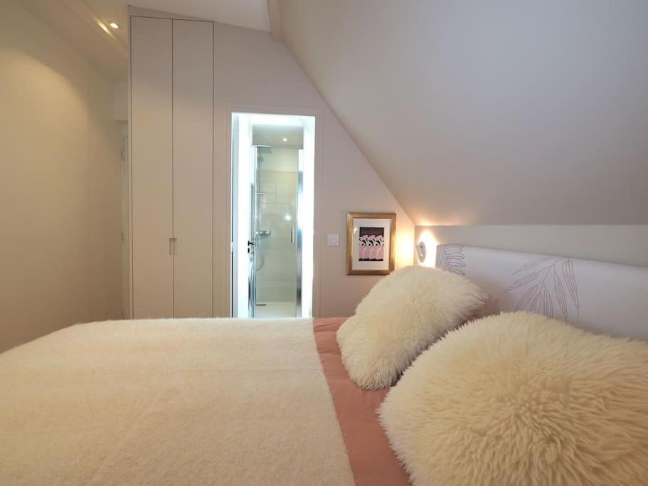a bedroom with two white furry pillows on a bed at Luxury flat with amazing view on Eiffel Tower in Paris