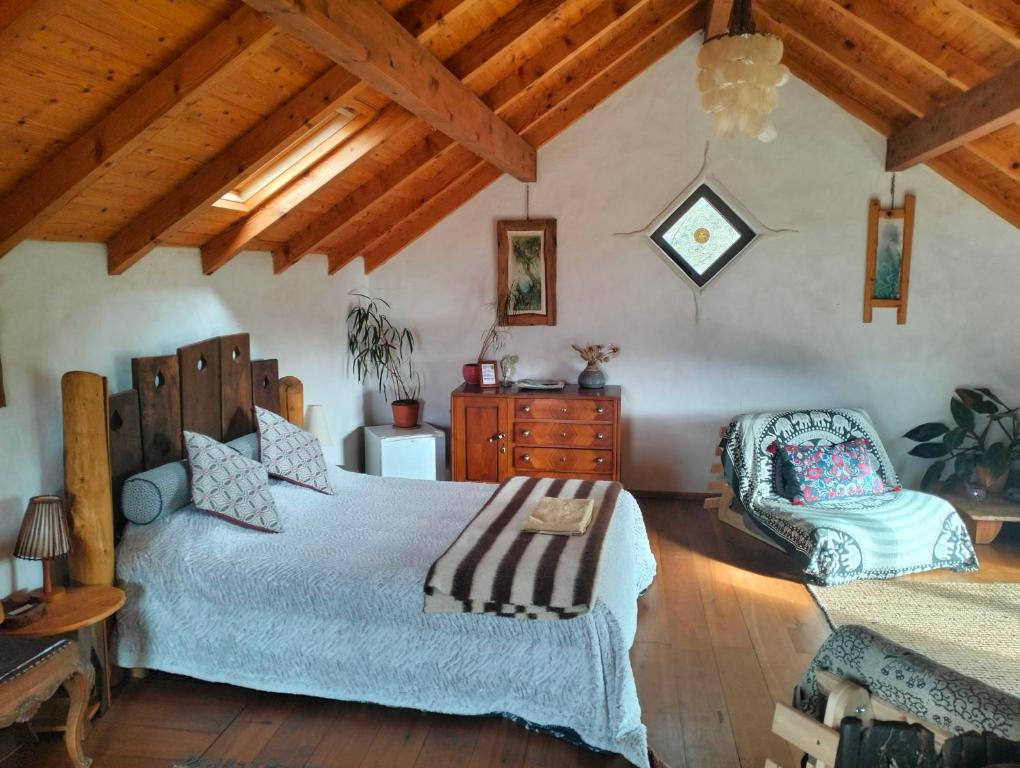 um quarto com uma cama grande e um tecto de madeira em O Homem Verde em Penela