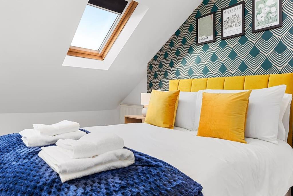 a bedroom with a bed with towels on it at The Holloway Suite- LongTerm Stays 15% Off Sleeps4 in London