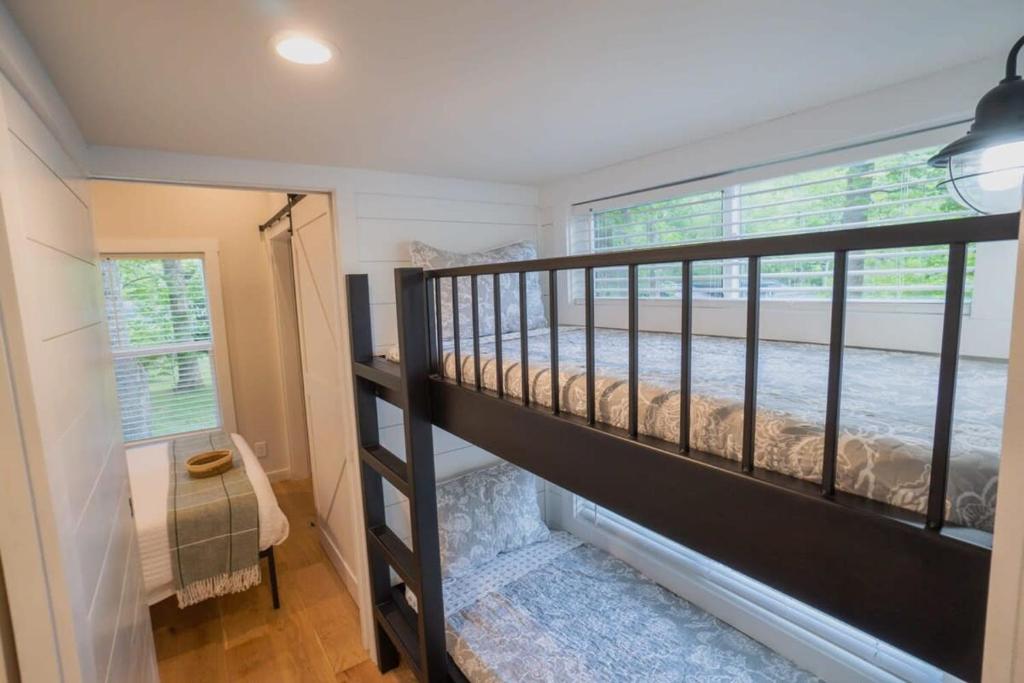 a bedroom with a bunk bed in a tiny house at Farmhouse Tiny home with fishing Pond - Oak Cabin in Gatlinburg