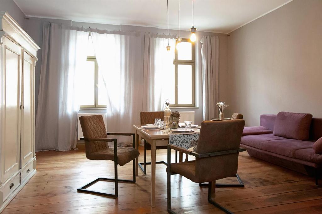 a living room with a table and a couch at Avancers - homelike living in Cottbus