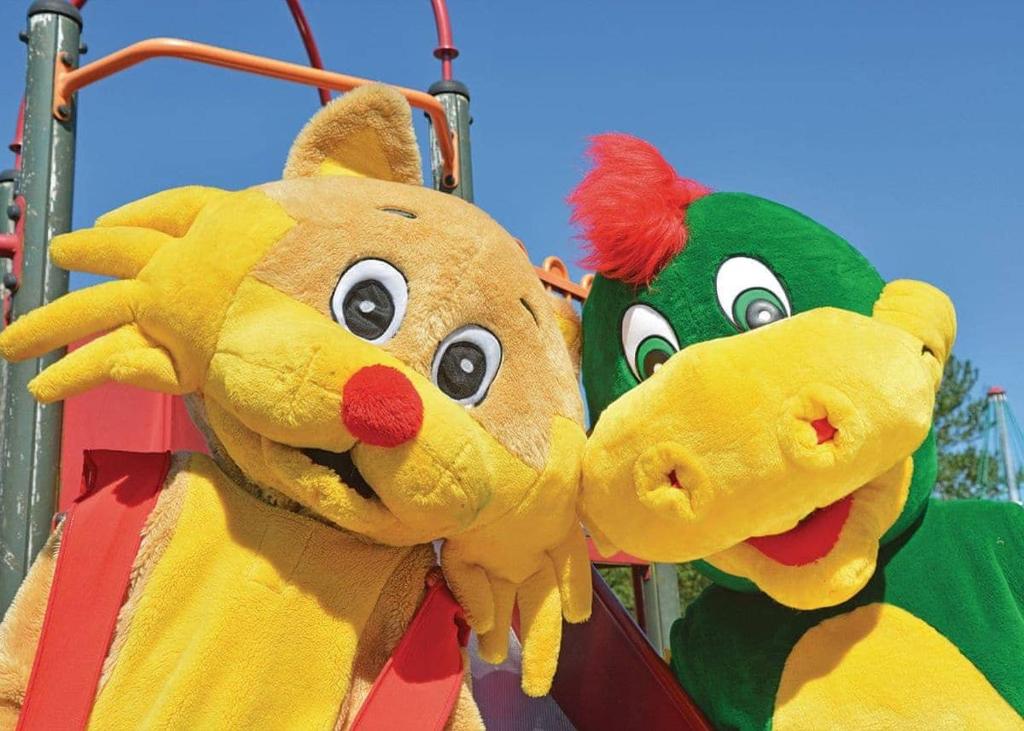 two stuffed animals are hanging on a playground ride at Ryan Bay in Dunragit
