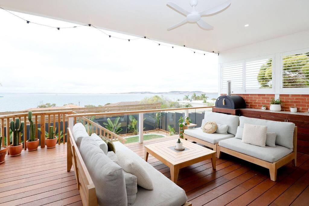 a living room with a view of the ocean at Palm Springs in Port Lincoln! in Port Lincoln