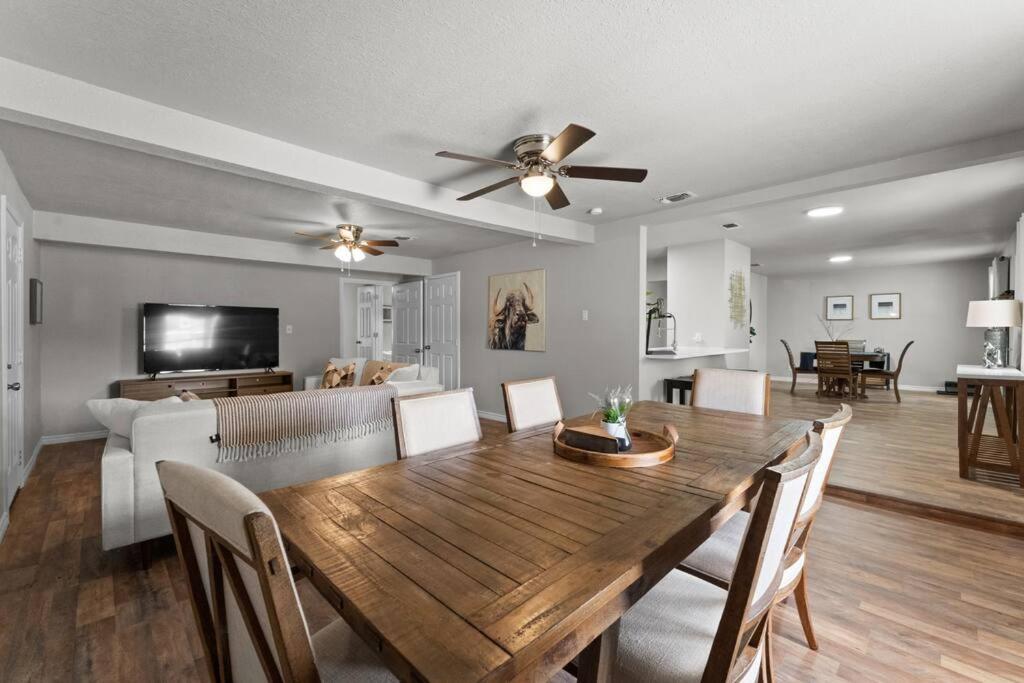 a dining room and living room with a wooden table at Steps to Lackland AFB & SeaWorld in San Antonio