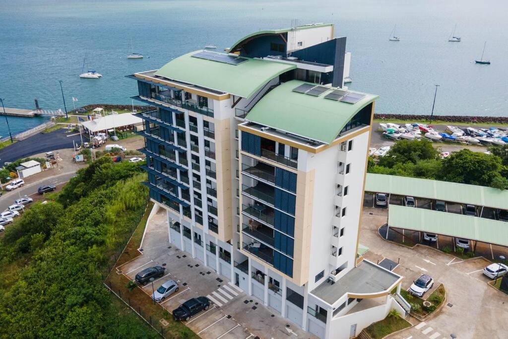 an aerial view of a large building with a parking lot at Appartement Corail Bleu in Fort-de-France