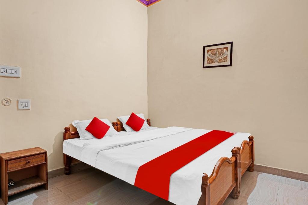 A bed or beds in a room at Hotel Om Residency