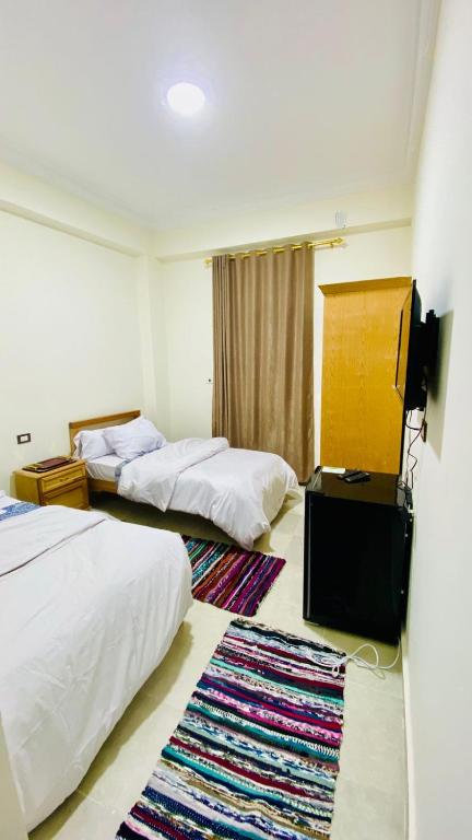Postel nebo postele na pokoji v ubytování RAAK HOTEL فندق راك