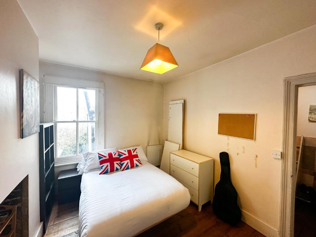 a small bedroom with a bed and a window at 58 Alloa townhouse in London