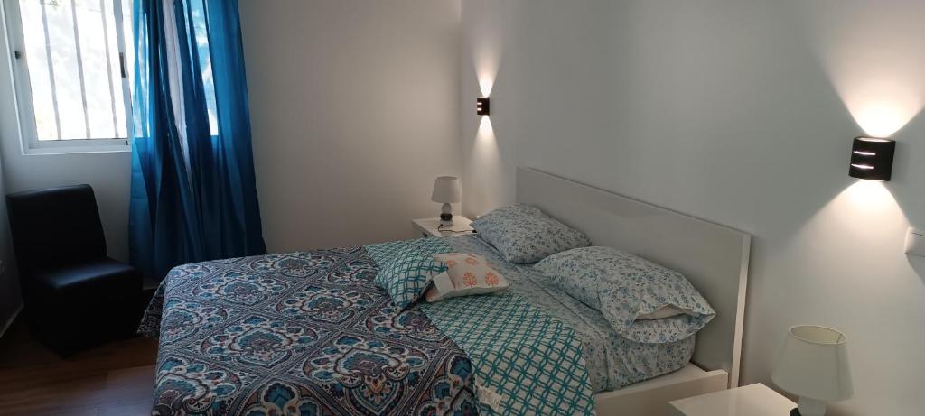 a bedroom with a bed with a comforter and pillows at Residência Águia in Praia