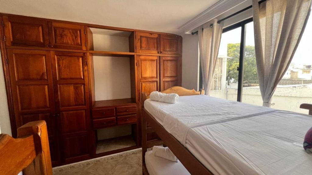 a bedroom with a bed and a large window at LIVE APARTMENTS Cartagena in Cartagena de Indias