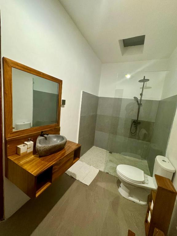 a bathroom with a sink and a toilet and a mirror at Villa in Canggu