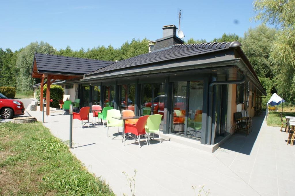 a pavilion with chairs and tables in a yard at Motel D'ornex in Ornex
