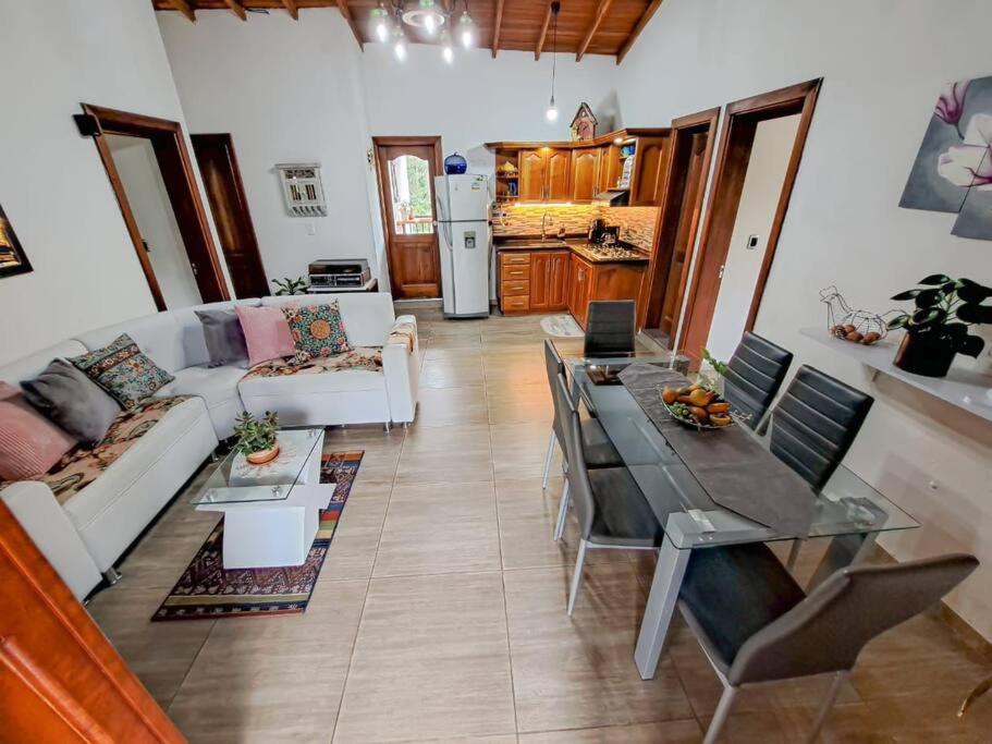 a living room with a couch and a table at Casa familiar vacacional in Jardin