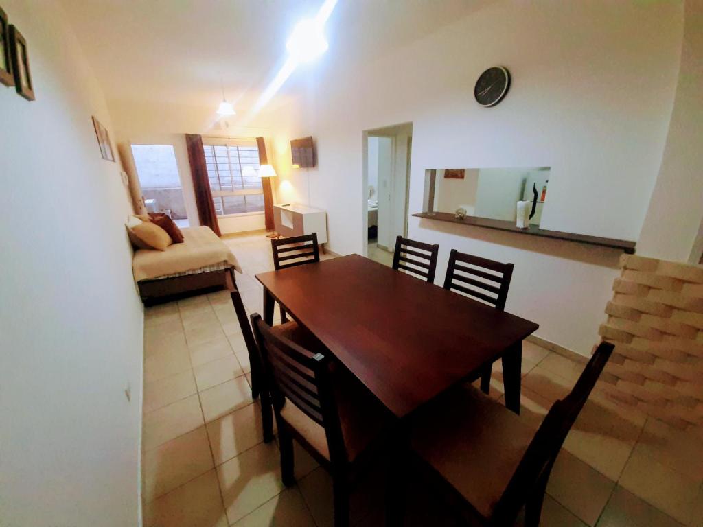 a dining room with a wooden table and chairs at A&S Mendoza in Barraquero