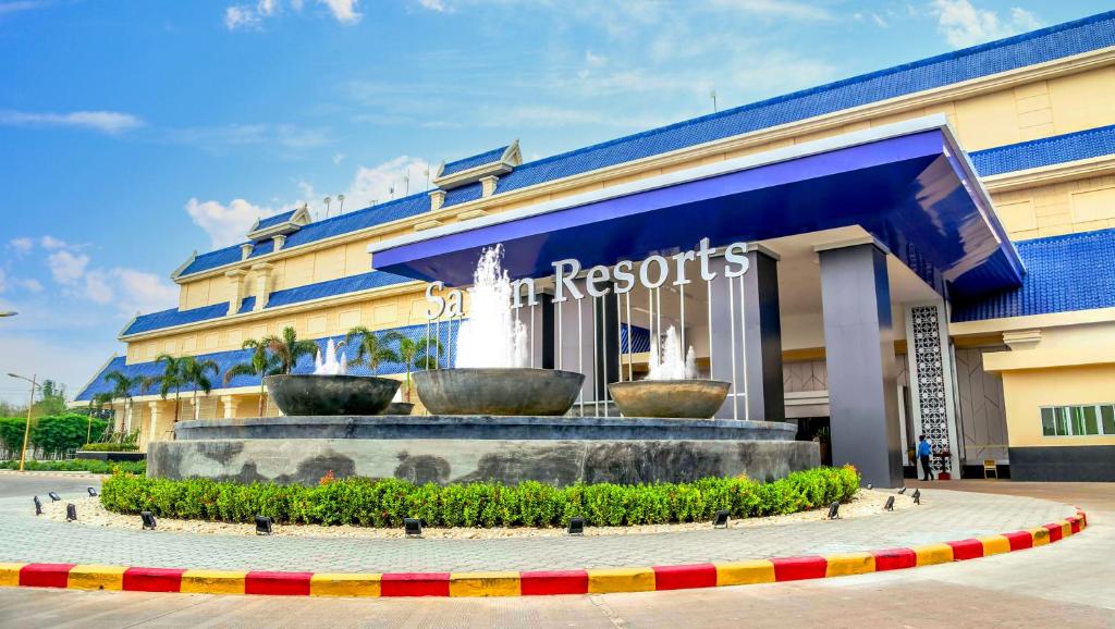 a building with two large fountains in front of it at Savan Resorts in Savannakhet