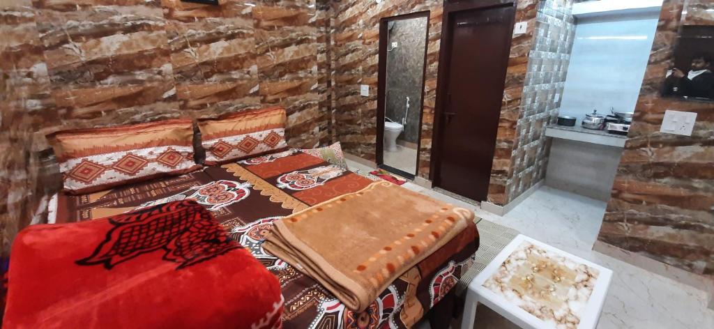 una camera con un divano rosso e un muro di mattoni di Luxury flat in foreigner areof lajpat nagar with fully equipped kitch a Nuova Delhi