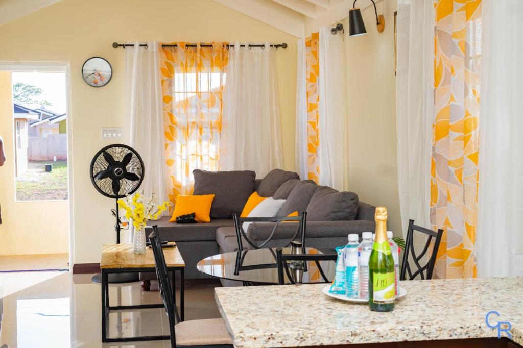 a living room with a couch and a table at Charming refuge at Colbeck Manor in Old Harbour