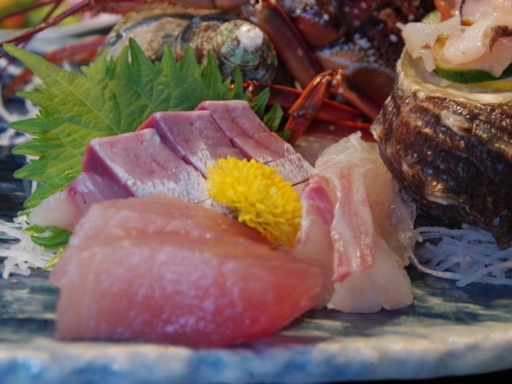 a plate of food with sushi and other foods at あじ彩の宿小浜荘 in Toba