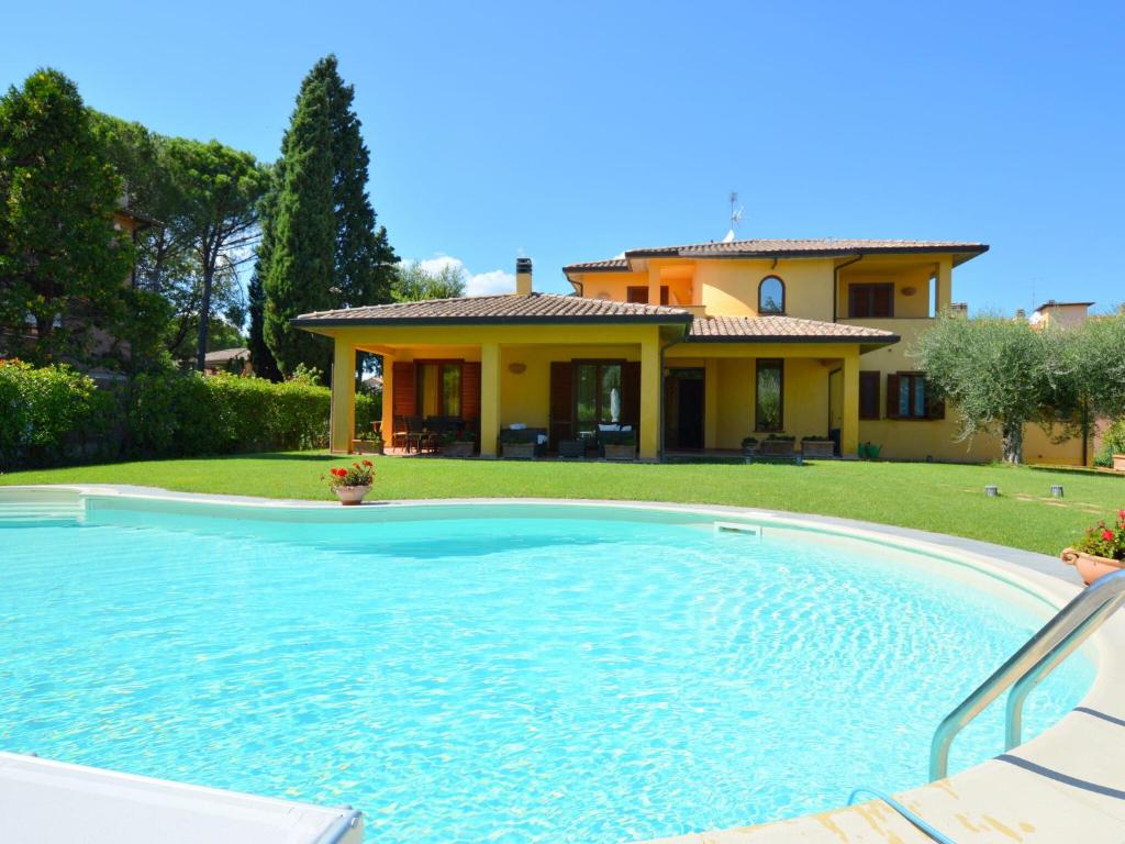 a swimming pool in front of a house at Pretty villa in Marsciano with nice garden and private pool in Marsciano