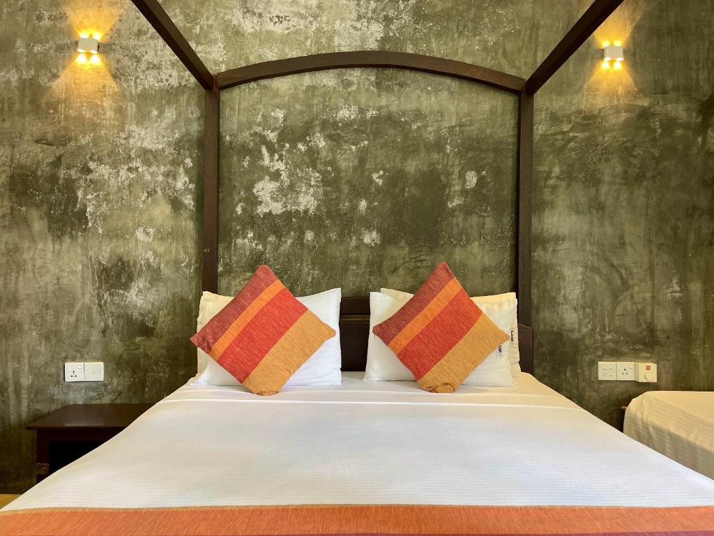 Postel nebo postele na pokoji v ubytování Olanro Hotel Negombo