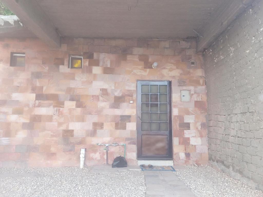 a building with a brick wall with a door at Mooody nobin haws in Abu Simbel