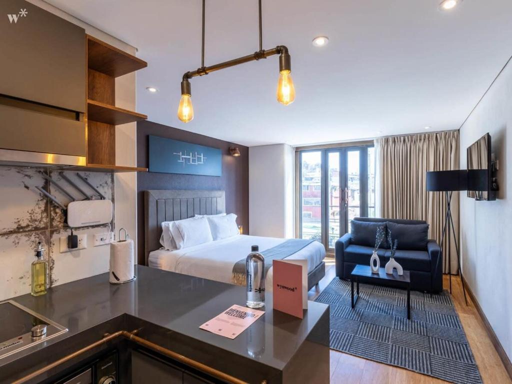 a hotel room with a bed and a desk at Classy Loft in La Candelaria in Bogotá