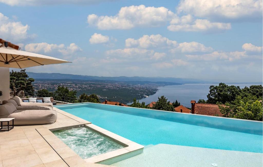 a swimming pool with a view of the water at 3 Bedroom Cozy Home In Bregi in Breza