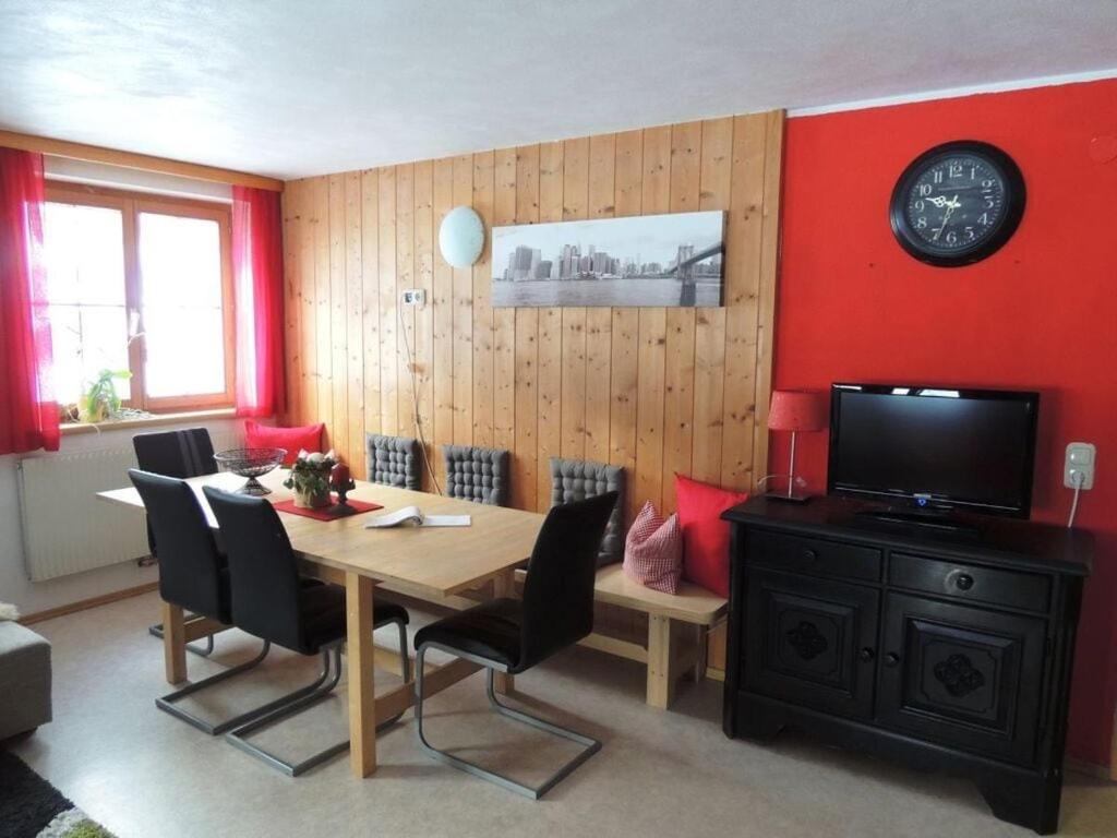 a dining room with a table with chairs and a television at Holiday apartment Rüf Stefanie 