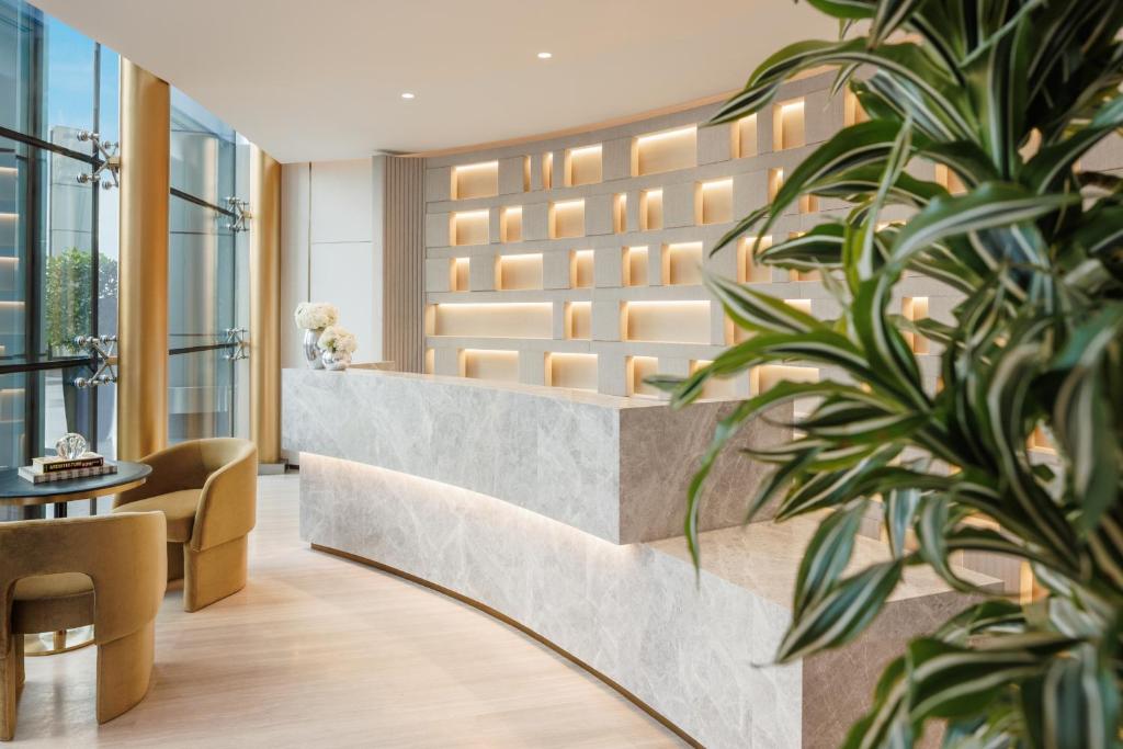 a lobby of a hotel with a potted plant at Jumeirah Living World Trade Centre Dubai in Dubai