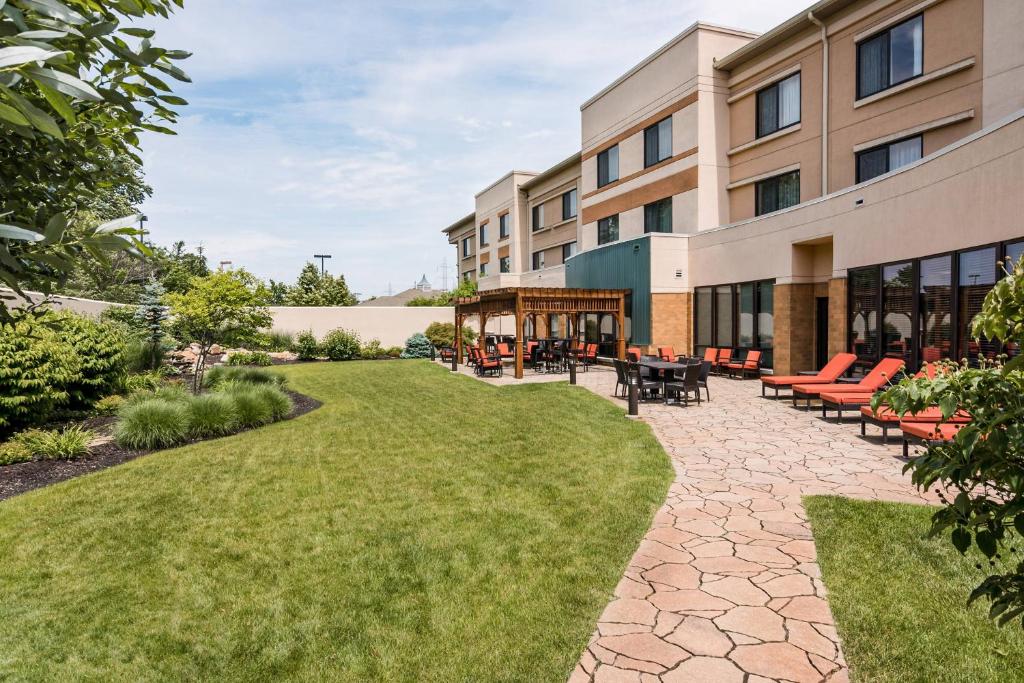 an exterior view of a building with a patio and grass at Courtyard by Marriott Lafayette in Lafayette