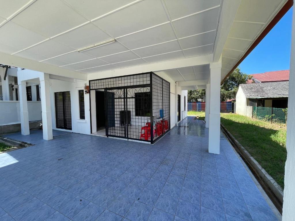 a covered area of a house with a cage at Rahmani Homestay in Kota Kinabalu