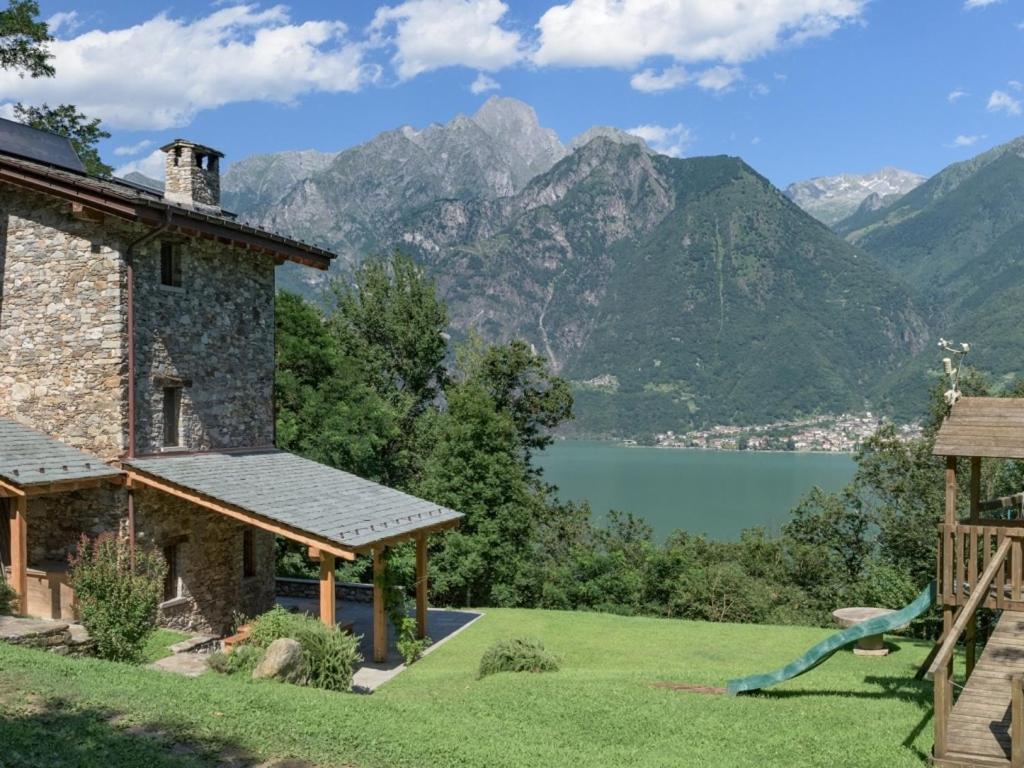 a house with a view of a lake and mountains at Villa Rustica in Sorico