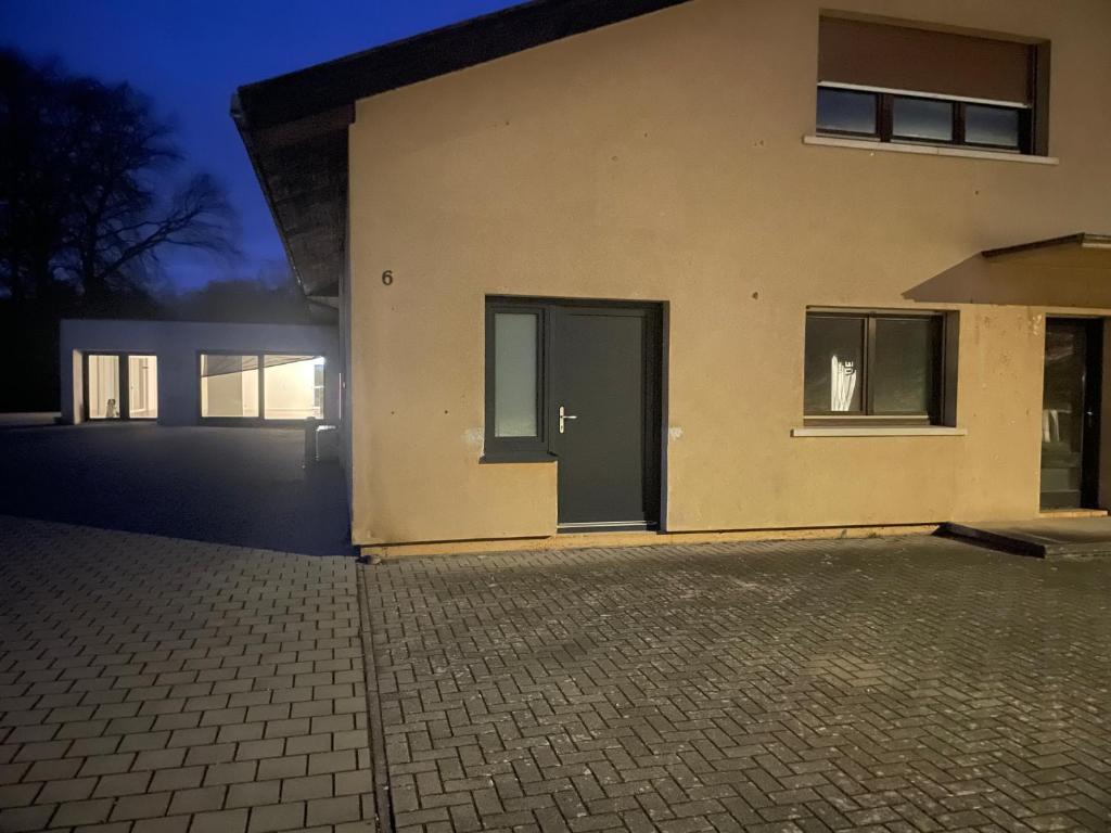 a building with doors on the side of it at Appartement 50M² in Seltz