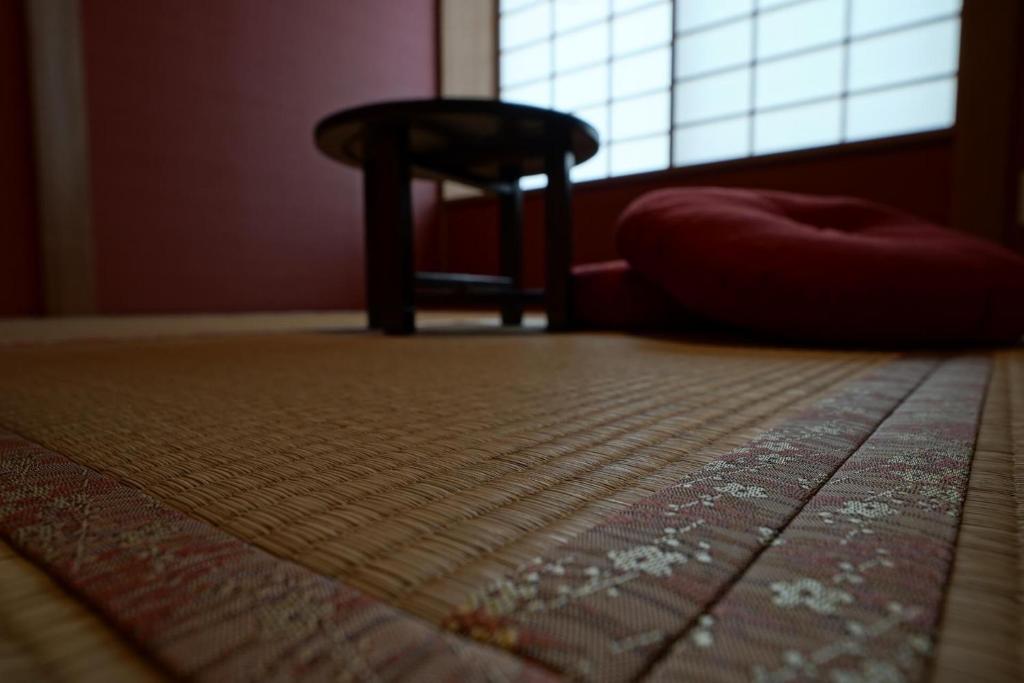 a room with a rug and a chair and a window at YAKATA - Vacation STAY 58651v in Yuzawa