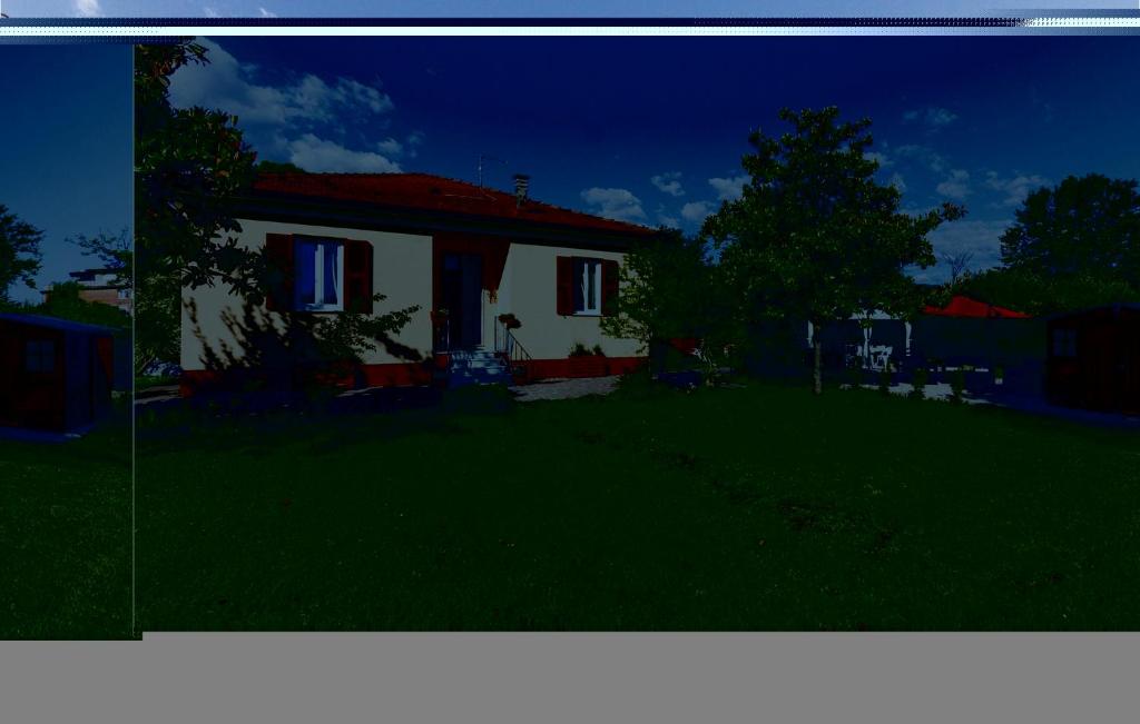 a small white house with a red roof at Casa Clo in Marina di Massa